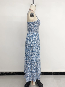 Detail of blue floral maxi dress showing smocked elastic bodice and thin straps