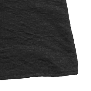 Detailed macro view of black crinkle texture fabric with premium stitching on the edge