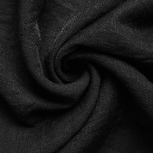Macro shot of high-quality black textile fabric with detailed woven texture and soft drape
