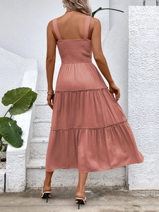 Back view of a dusty pink midi dress featuring tiered skirt and ruched elastic waist