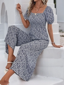 Detail of floral print jumpsuit with square neck, puff sleeves and high waist design