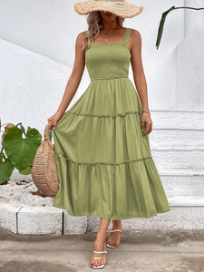 Detail of sage green tiered maxi dress featuring a smocked bodice and square neckline