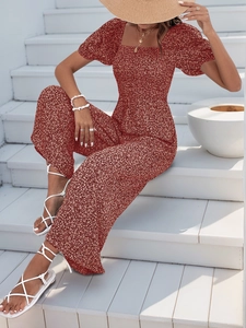 Detail of red floral romper with square neck, puff sleeves and high waist wide leg cut