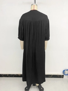 Back view of a black ethnic midi dress with pleated details and breathable fabric