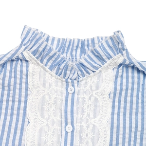 Close-up of frill collar and intricate lace detailing on blue striped women shirt