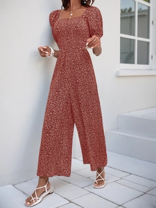 Detail of vintage red floral jumpsuit with square neck, puff sleeves and high waist design