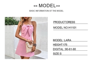 Detail of pink mini dress featuring a large front bow and thin shoulder straps