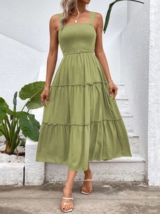 Detail of olive green sleeveless tiered dress featuring a shirred bodice and summery ruffles