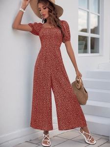 Detail of floral printed jumpsuit with square neck and puff sleeves in rust red color