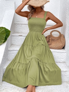 Close-up of olive green smocked waist summer maxi dress with tiered cake-style skirt