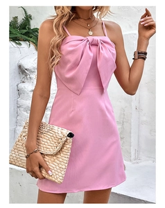 Detail of pink backless mini dress with a large bow and subtle vertical texture fabric