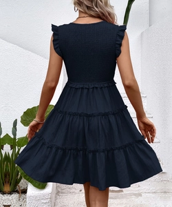 Detailed back view of navy blue smocked summer dress with tiered skirt and ruffled straps