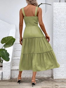 Back view of sage green tiered summer dress featuring comfortable smocked bodice detail