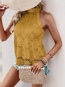 Close-up of mustard yellow crochet lace halter top with detailed floral hollow pattern