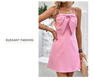 Detail shot of an elegant pink backless dress featuring a large front bow and thin straps