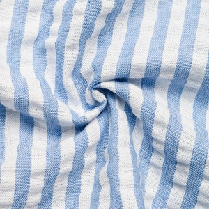 Detailed macro view of the breathable blue and white striped cotton-linen fabric texture
