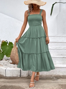 Sage green tiered summer maxi dress with shirred bodice and wide shoulder straps detail