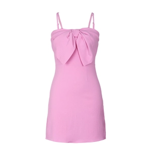 Detail of the large decorative pink bow and delicate texture on a summer slip dress
