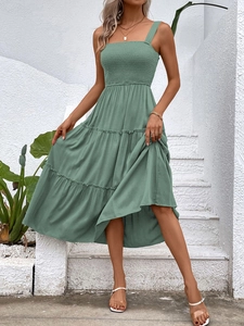 Detail of smocked square neck and tiered layers on dark green summer midi dress