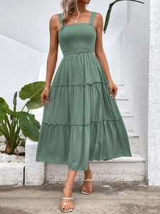 Close-up of sage green tiered maxi dress featuring smocked bodice and wide shoulder straps