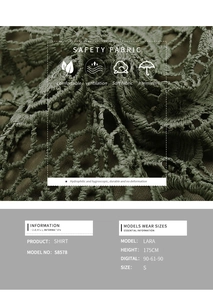 Detail of soft breathable lace crochet fabric on dark green halter neck shirt