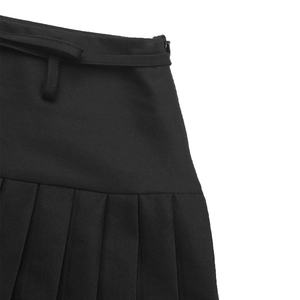 Detail of black pleated skirt featuring waist loops and a hidden side zipper closure