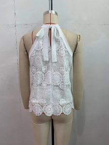Detailed view of white crochet lace halter top with sunflower patterns and neck tie
