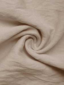 Detailed macro view of natural linen blend fabric texture for summer V-neck jumpsuit