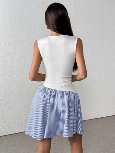 Detail of a casual sleeveless mini dress featuring a blue striped skirt and open back
