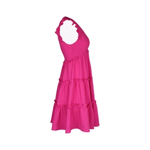 Close-up of shirred bodice and tiered layers on a rose red summer ruffle dress