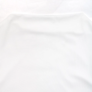 Close-up of white vertical ribbed knit fabric and high neckline detail of the dress