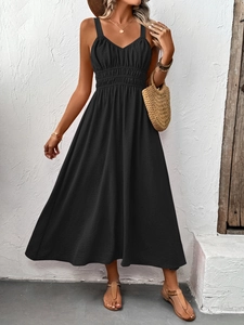 Detail of black V-neck sleeveless maxi dress with pleated waist and textured fabric