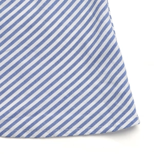 Close-up of blue and white striped fabric showing neat hem stitching and texture