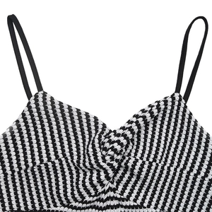 Detail of knit striped jumpsuit featuring thin straps and front twist design