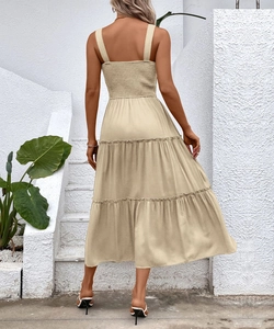 Detail of smocked elastic back and tiered skirt on a beige sleeveless summer midi dress