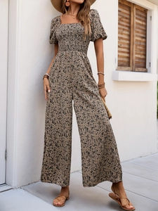 Detail of smocked bodice and vintage floral print on a short sleeve wide-leg jumpsuit