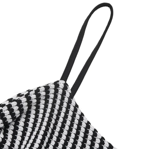 Close-up of the knitted texture and fine black straps on a striped summer jumpsuit