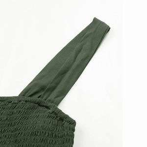 Detail showing smocked elastic fabric and shoulder strap of the dark olive summer dress