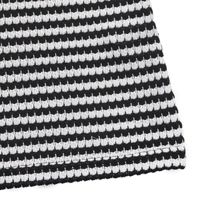 Macro shot of the black and white striped knit texture on sleeveless jumpsuit fabric