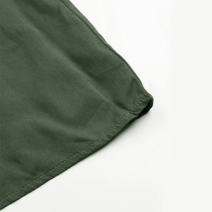Detailed close-up of olive green twill fabric showing high-quality stitching and texture