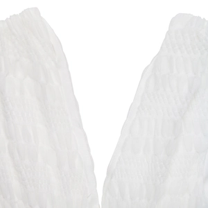 Detail of white smocked fabric with fine elastic pleats and smocking texture