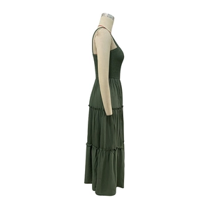 Detailed side view of dark green tiered summer maxi dress with smocked bodice design