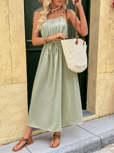 Detail of sage green pleated maxi dress featuring spaghetti straps and drawstring waist