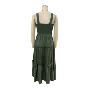 Detail of smocked elastic back and tiered layered skirt on a dark green summer maxi dress