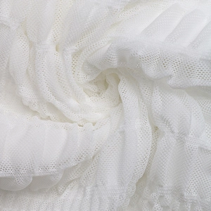 Close-up of lightweight white mesh fabric with fine breathable texture and soft layers