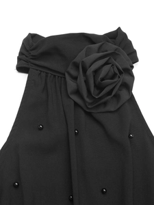 Macro detail of black halter bodysuit featuring 3D fabric rose and beaded pearl accents