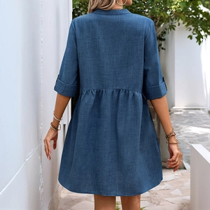 Back view of a casual loose V-neck denim blue shirt dress with mid-length sleeves