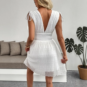 White smocked sleeveless V-neck mini dress with elegant shoulder bow ties and open back