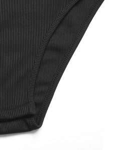 Close-up of black ribbed knit bodysuit showing high-quality stitching and texture