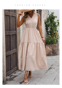 Detail of apricot V-neck sleeveless maxi dress featuring a textured tiered cake skirt